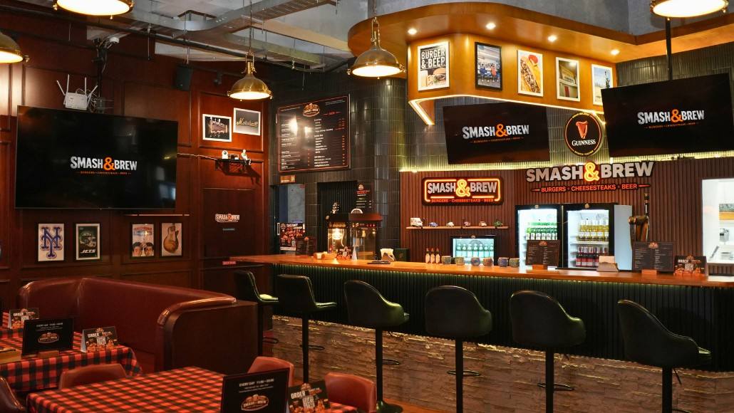 The bar — stools, taps, and screens
