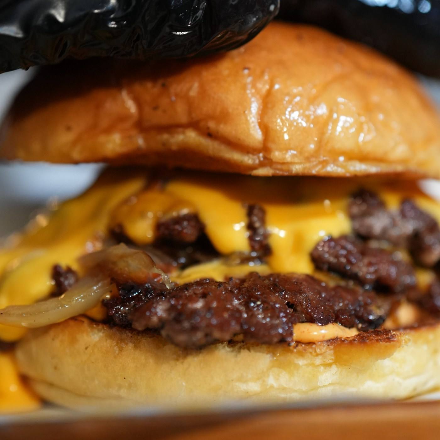 Smash burger — melted cheese, caramelized onions, glossy bun